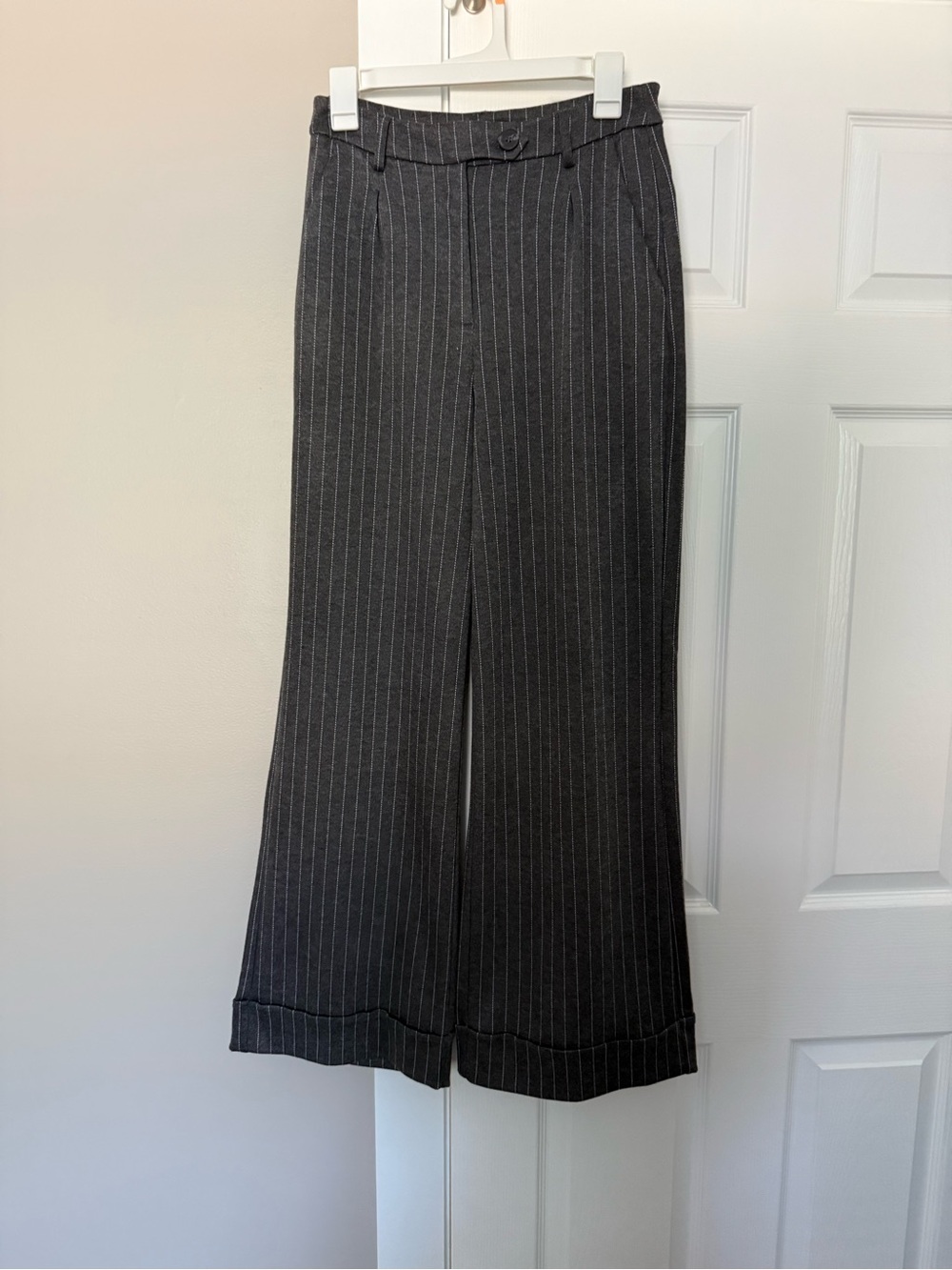 Gray pinstripe trousers. M.